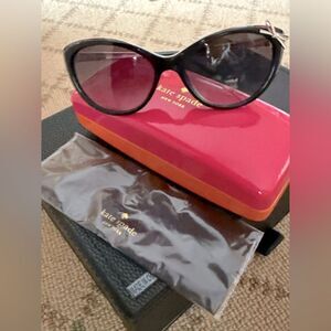 kate spade black livia cat eye sunglasses w silver white bow on side.  NWOT
